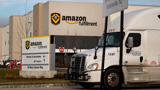 A truck drives past the Amazon.com fulfillment center in Robbinsville, New Jersey, Nov. 30, 2015.