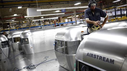 A factory worker installs rivets into the roof of an Airstream Inc. RV travel trailer on the production line at the company's assembly plant in Jackson Center, Ohio.
