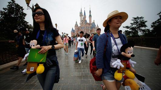 People walk at Shanghai Disney Resort during a three-day Grand Opening event in Shanghai, China, June 15, 2016.
