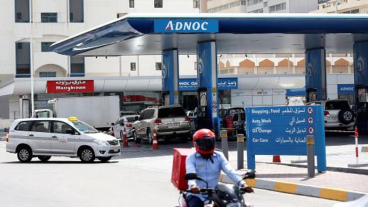 A man rides a motorcycle near an ADNOC petrol station in Abu Dhabi, United Arab Emirates July 10, 2017.