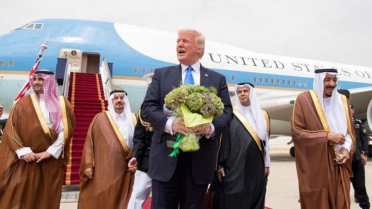 President Donald Trump gestures as Saudi Arabia's King Salman bin Abdulaziz Al Saud (R) stands next to him during a reception ceremony in Riyadh, Saudi Arabia, May 20, 2017.