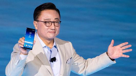 DJ Koh, president of mobile communications business at Samsung, holds up the Samsung Galaxy Note 8 smartphone during a launch event for the new product, August 23, 2017.