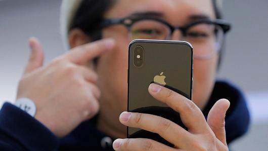 An attendee uses a new iPhone X during a presentation for the media in Beijing, China October 31, 2017.