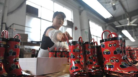 A woman works in a Macintosh boot factory in Lin'an, located in the east China province of Zhejiang.