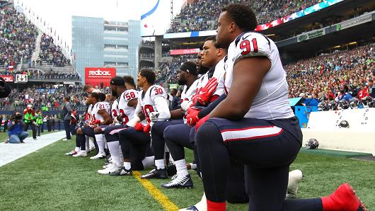 Members of the Houston Texans kneel during the national anthem before the game against the Seattle Seahawks at CenturyLink Field on October 29, 2017 in Seattle, Washington.