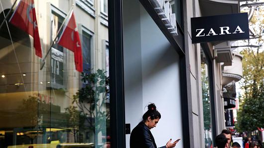 A shopper exits a fashion retailer Zara branch in an Istanbul upscale neighbourhood, Friday, Nov. 3, 2017. Shoppers at Zara in Istanbul have found unusual tags on their garments: put there by Turkish workers complaining they have not been paid for the manufacturing the merchandise in the store.
