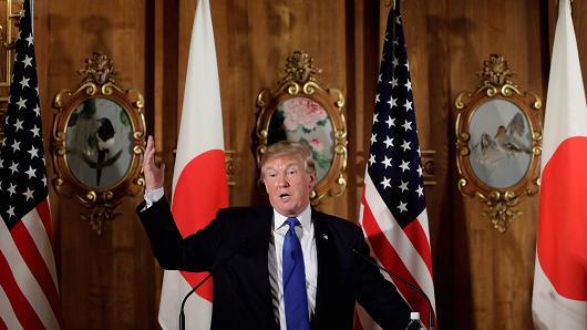 US President Donald Trump (C) and Japanese Prime Minister Shinzo Abe (not seen) hold a joint press conference after holding an inter-delegation meeting at Akasaka Palace in Tokyo, Japan on November 6, 2017.