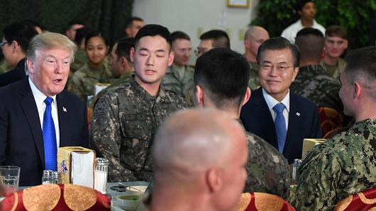 President Donald Trump talks to military personnel with South Korean President Moon Jae-In at Camp Humphreys in Pyeongtaek on November 7, 2017