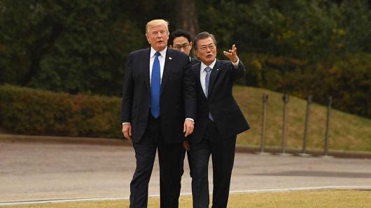 US President Donald Trump walks with South Korea's President Moon Jae-In on the grounds of the presidential Blue House in Seoul on Nov. 7, 2017.