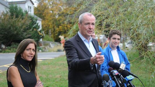 Democratic gubernatorial candidate Phil Murphy attends a news conference with wife Tammy Murphy and son Sam on Nov. 7, 2017 in Asbury Park, New Jersey.