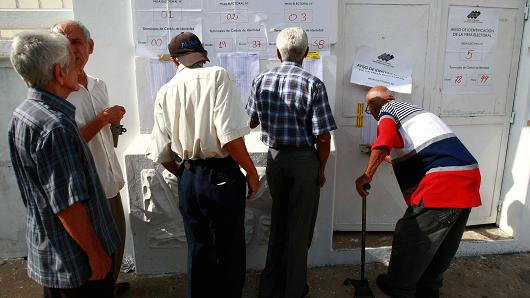 People check the information on a polling station during a nationwide election for new governors in Maracaibo, Venezuela, October 15, 2017.