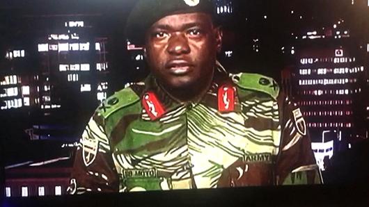 This screen grab taken early on November 15, 2017 from a television broadcast on the Zimbabwe Broadcasting corporation (ZBC) shows Zimbabwe Major General Sibusiso Moyo reading a statement at the ZBC broadcast studio in Harare. Zimbabwe's military appeared to be in control of the country on November 15 as generals denied staging a coup but used state television to vow to target 'criminals' close to President Robert Mugabe.