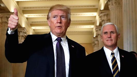 President Donald Trump gives a thumbs-up as he and Vice President Mike Pence depart the U.S. Capitol after a meeting to discuss tax legislation with House Republicans in Washington, November 16, 2017.