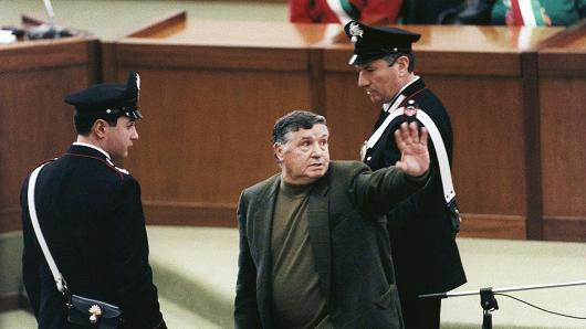 Salvatore Riina, aka Toto Riina, the most important figure of the Sicilian mafia, is brought to justice after evading police for 23 years at the Aula Bunker of Palermo courthouse on March 4, 1993 in Palermo, Italy.