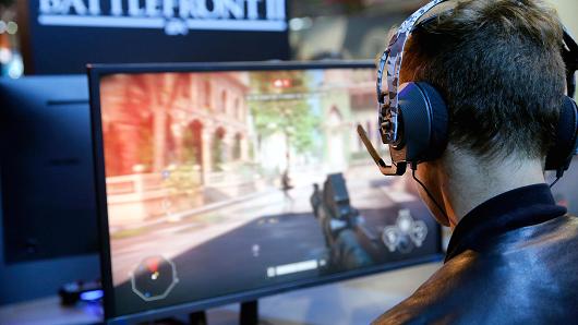 Gamers play the video game 'Star Wars Battlefront II' developed by DICE, Criterion Games and Motive Studios and published by Electronics Arts on Sony PlayStation game consoles PS4 Pro during the 'Paris Games Week' on October 31, 2017 in Paris, France.