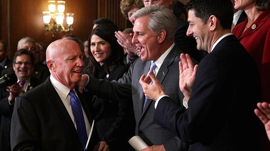 House Ways and Means Committee Chairman Rep. Kevin Brady (R-TX) is greeted by applause from (L-R) Rep. Kristi Noem (R-SD), House Majority Leader Rep. Kevin McCarthy (R-CA), and Speaker of the House Rep. Paul Ryan (R-WI) during an event at the Capitol to celebrate the passing of the tax reform bill November 16, 2017 in Washington, DC.