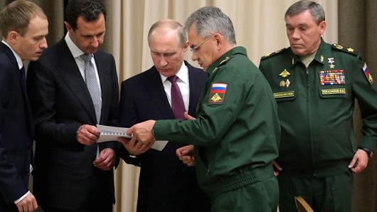 Syria's President Bashar al-Assad (2nd L), Russia's President Vladimir Putin (C back), Russia's Defense Minister Sergei Shoigu (C front), and his first deputy, Chief of the General Staff of the Russian Armed Forces Valery Gerasimov (R) are pictured during a meeting at Bocharov Ruchei state residence in Sochi, Russia.