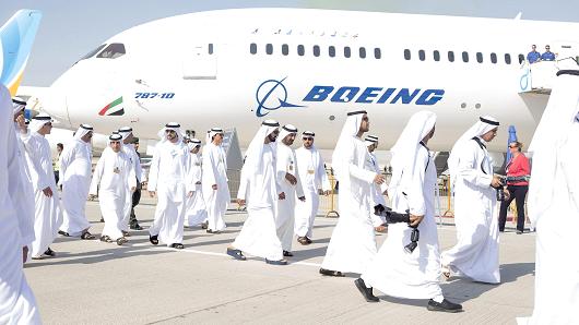 Sheikh Mohammed bin Rashid Al Maktoum, United Arab Emirates vice president and prime minister, center blue sandals, passes a Boeing Co. 787-10 passenger aircraft, operated by Emirates Airlines, during the 15th Dubai Air Show at Dubai World Central (DWC) in Dubai, United Arab Emirates, on Monday, Nov. 13, 2017.
