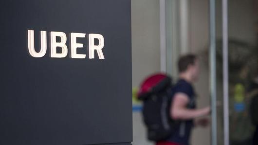 An Uber signage is displayed outside the company's headquarters building in San Francisco, California, on June 21, 2017.