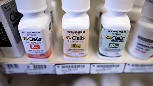 Bottles of Eli Lilly's Cialis brand medication on a pharmacy shelf in Princeton, Illinois.
