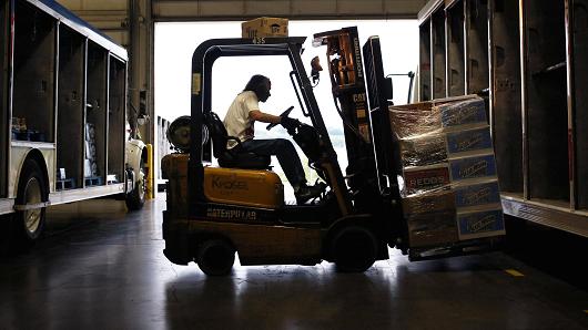 A worker uses a forklift to load a delivery truck with MillerCoors beverages at the Stagnaro Distributing facility in Cincinnati, Ohio.
