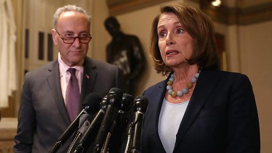 Senate Minority Leader Charles Schumer (L) ,D-N.Y., looks on as House Minority Leader Nancy Pelosi, D-Calif., speaks to reporters during a news conference at the U.S. Capitol in Washington.