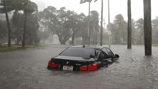 A car is seen in a flooded street as Hurricane Irma passes through on September 10, 2017 in Miami, Florida.