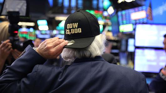 A trader wears a hat reading Dow 23,000 on the floor of the New York Stock Exchange (NYSE) on October 17, 2017 in New York City.