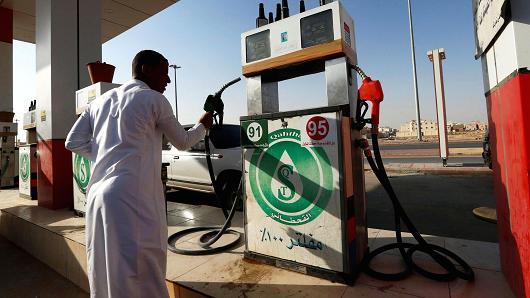 A man holds a nozzle at a petrol station in Riyadh, Saudi Arabia October 8, 2017.