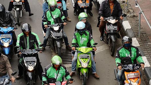 Go-Jek and other motorcycle riders on a street in Jakarta, Indonesia on Monday, March 21, 2016.