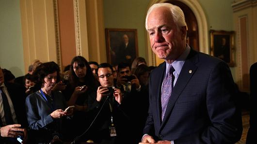 Senate Majority Whip Sen. John Cornyn (R-TX) (R) pauses during a news briefing after a weekly Senate Republican Policy Luncheon at the Capitol November 28, 2017 in Washington, DC.