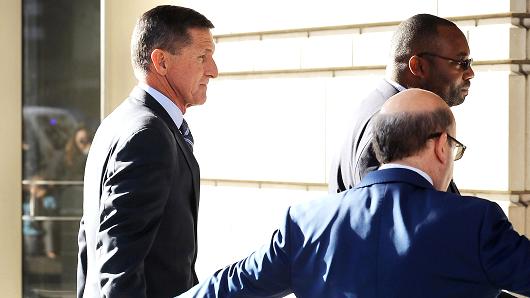Michael Flynn (L), former national security advisor to President Donald Trump, arrives for his plea hearing at the Prettyman Federal Courthouse December 1, 2017 in Washington, DC.
