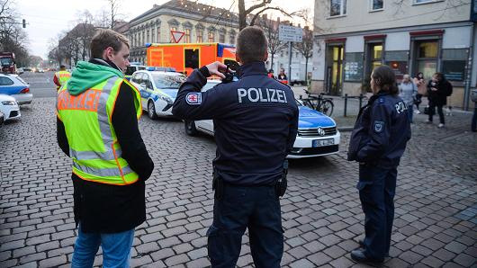 German policemen stand guard on a steet on December 1, 2017 after a suspicious object prompted the evacuation of a Christmas market in Potsdam.