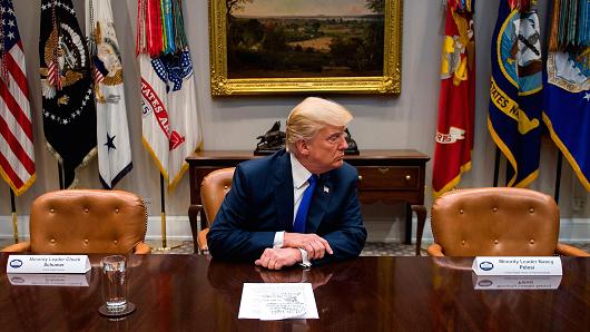 President Donald Trump (C) makes a statement from the Roosevelt Room next to the empty chairs of Senate Minority Leader Chuck Schumer (L), D-New York, and House Minority Leader Nancy Pelosi (R), D-California, after they cancelled their meeting at the White House in Washington, DC, on November 28, 2017.