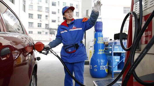 A female staff works at a gas station in Huaibei, Anhui province, China.