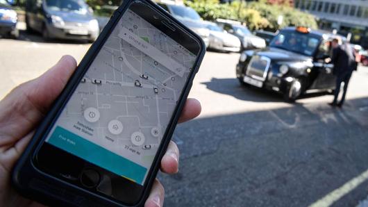 A phone displays the Uber ride-hailing app on September 22, 2017 in London, England. Uber is appealing Transport for London's decision not to renew its operating license.