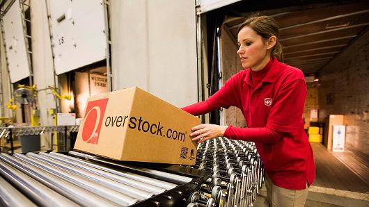 A United Parcel Service Inc. (UPS) worker loads orders onto a truck in the shipping area at the Overstock.com Inc. distribution center in Salt Lake City, Utah.