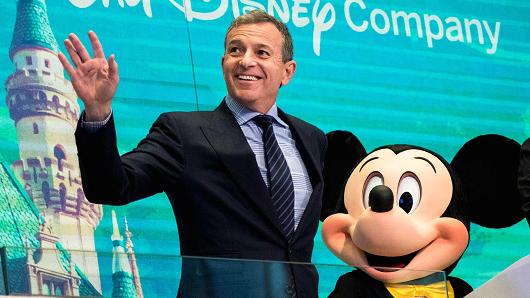 Chief executive officer and chairman of The Walt Disney Company Bob Iger and Mickey Mouse look on before ringing the opening bell at the New York Stock Exchange (NYSE), November 27, 2017 in New York City.