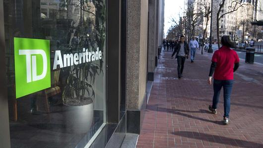 Pedestrians pass in front of a TD Ameritrade location in San Francisco, California.