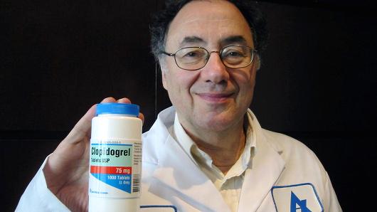 Barry Sherman poses with a bottle of clopidogrel tablets, August 14, 2006 at company headquarters in Weston, Ontario, Canada.