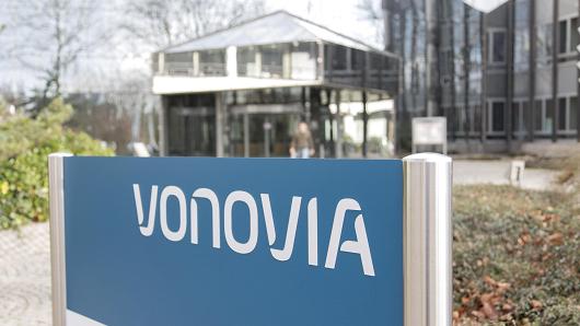 A sign stands outside the headquarter offices of Vonovia SE in Bochum, Germany, on Thursday, Feb. 11, 2016. Vonovia failed to get enough shares to acquire Deutsche Wohnen AG after a four-month takeover battle between Germany's largest property companies, ending what would have been the biggest ever deal in the country's real estate industry.