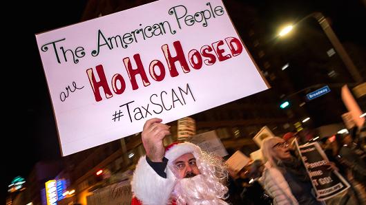 A protester dressed as Santa during a demonstration against the Republican tax bill in Los Angeles, California on December 4, 2017.