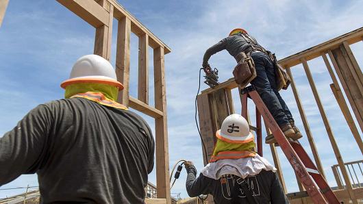 Contractors raise framed walls at the PulteGroup Onyx housing development in San Jose, California, May 10, 2017.