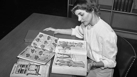 In this August 26, 1948 file photo, Ruth Parrington, librarian in the art department of the Chicago Public Library, studies early Sears Roebuck catalogs in the library's collection, in Chicago.