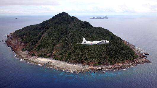 A Japanese Maritime Self-Defense Force flying over the disputed islets known as the Senkaku islands in Japan and Diaoyu islands in China, in the East China Sea.