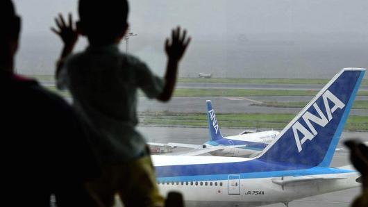 A child watches All Nippon Airways (ANA) jetliners on the tarmac at Haneda international airport in Tokyo.