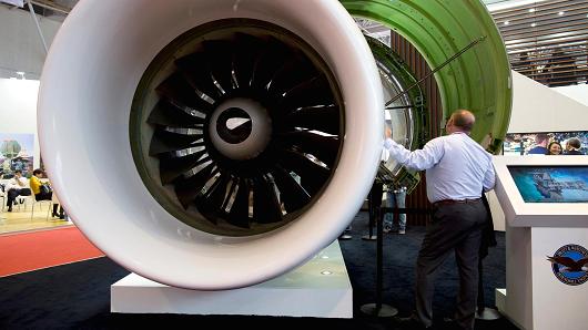 An attendee looks at an aircraft engine from Pratt & Whitney, a unit of United Technologies, on display during the China International Aviation & Aerospace Exhibition in Zhuhai, China.