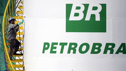 A worker paints a tank of Brazil's state-run Petrobras oil company in Brasilia, Brazil September 30, 2015.