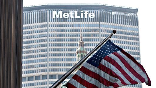 A U.S. flag flies outside a building near the MetLife Building, home of the MetLife Inc. headquarters, rear, in New York.