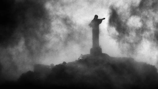 A general view of Christ the Redeemer, a statue of Jesus Christ, through the dark clouds during the Netherlands training session at the 2014 FIFA World Cup Brazil held at the Estadio Jose Bastos Padilha Gavea on June 19, 2014 in Rio de Janeiro, Brazil.